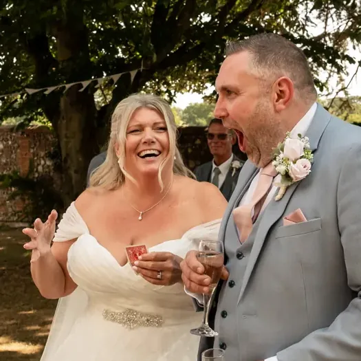 A bride laughing at Matt Parrou2019s magic in a garden