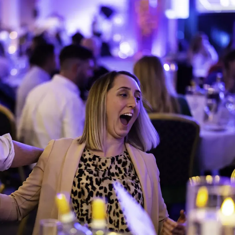 Awards dinner guests screaming at a trick