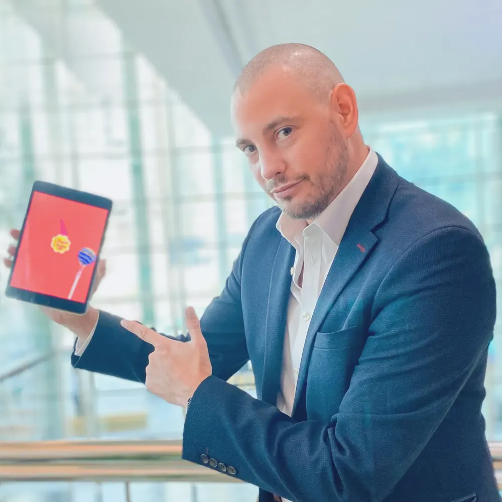 Bespoke magic by Matt Parro, pointing at an iPad trick