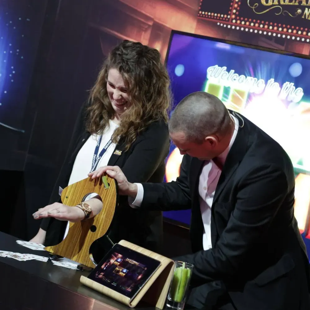 Birmingham magician Matt Parro performing for a visitor on an exhibition stand