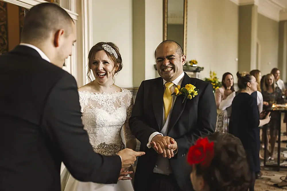 Bride and groom laughing at magic