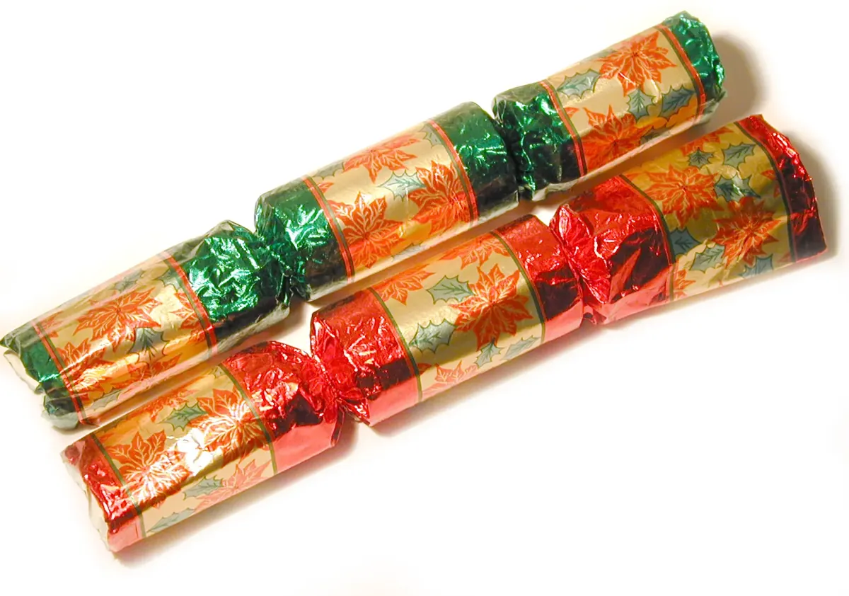 Christmas crackers laid out on a party table