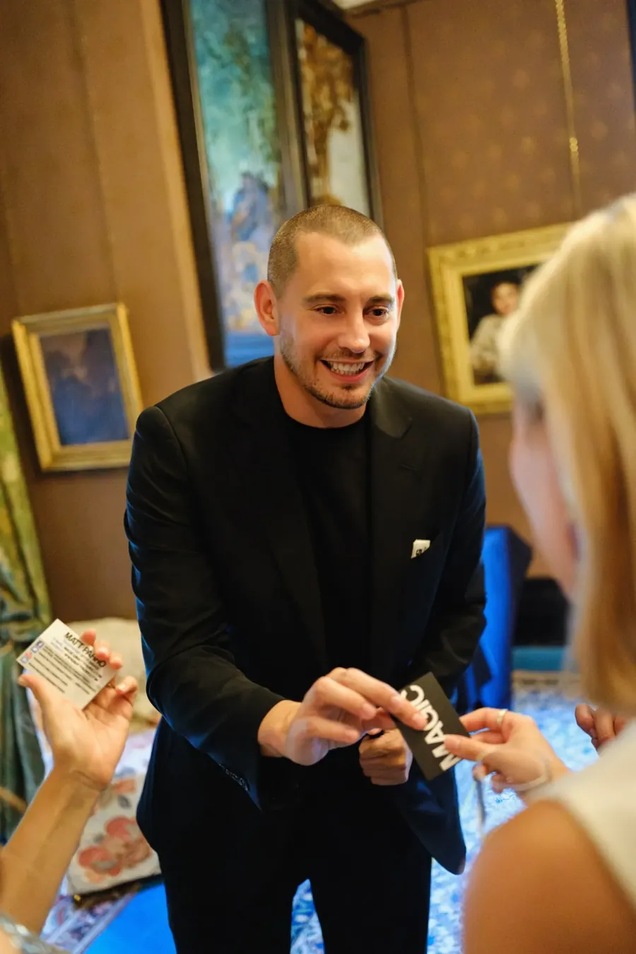 Event magician Matt Parro performing close-up magic for a guest