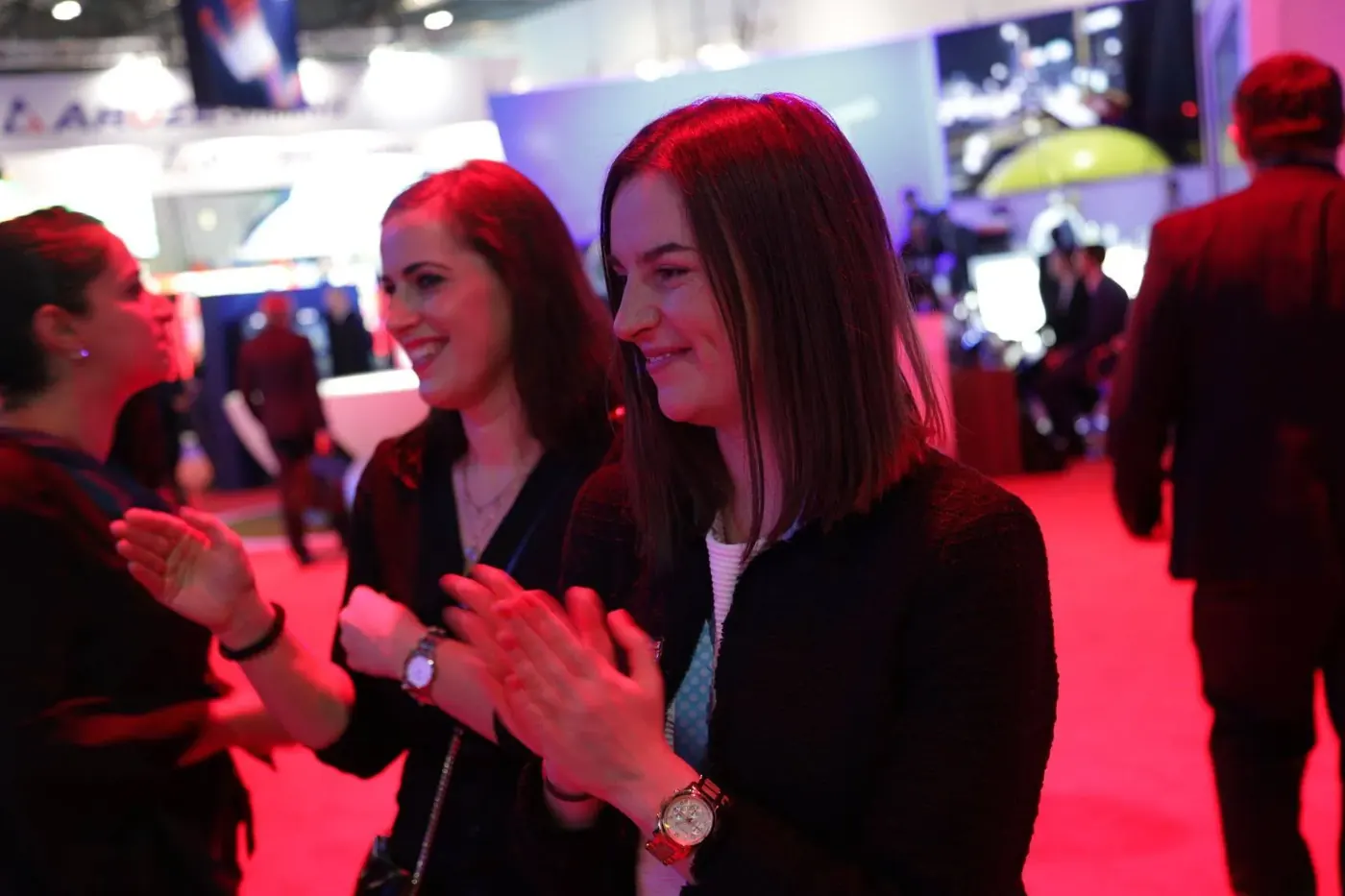 Exhibition visitors applauding trade show magician Matt Parro on a stand