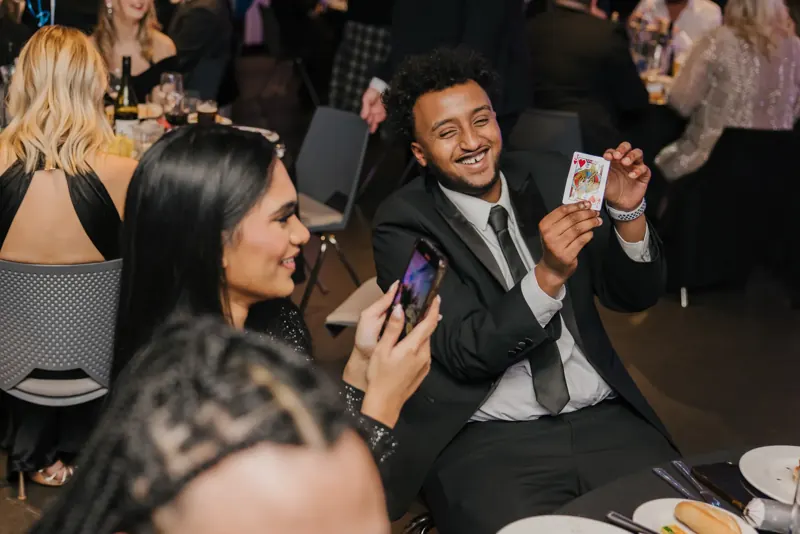 Guests laughing at a card reveal