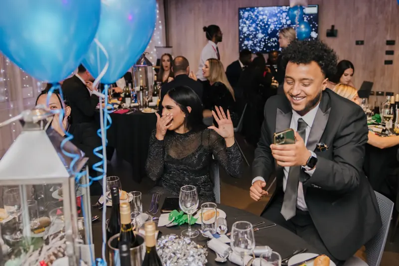 Gala guests with their hands on their heads after a trick