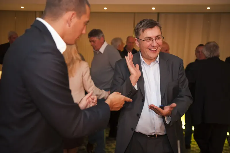 Guest amazed by Matt Parro's close-up magic at a company reception