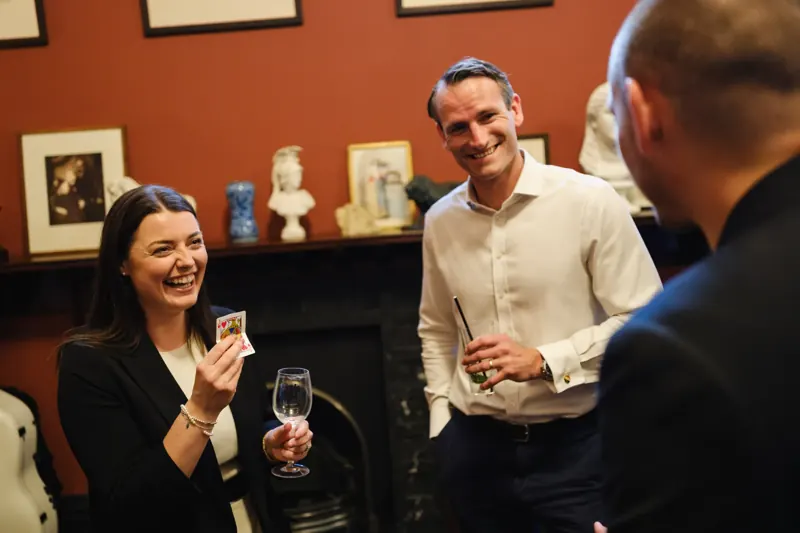 Guest laughing as she holds her card at a Dorset corporate event