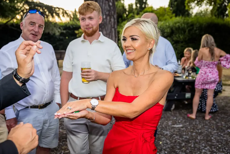 Guest reacting to Matt Parrou2019s magic at a garden party