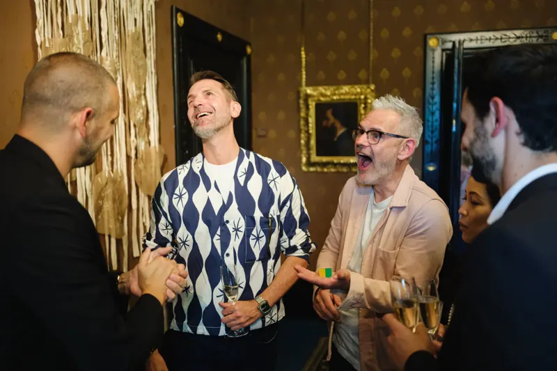 Guests laughing at a cocktail reception