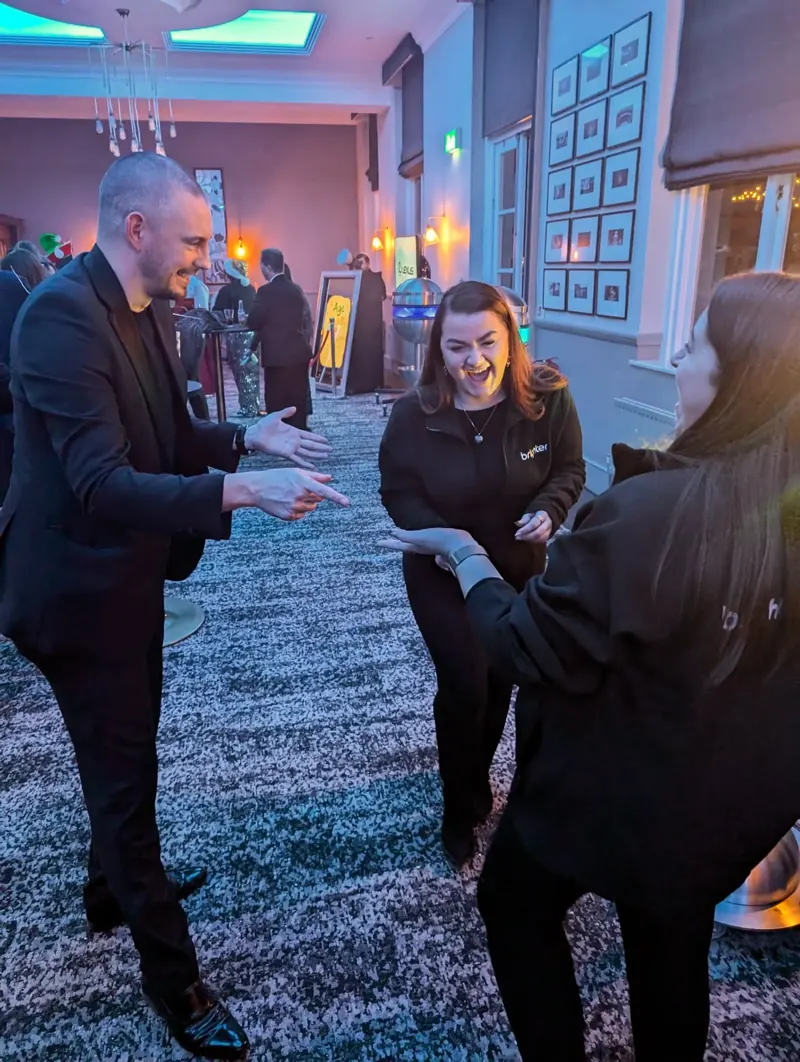 Guests laughing at Matt Parrou2019s magic at a private party