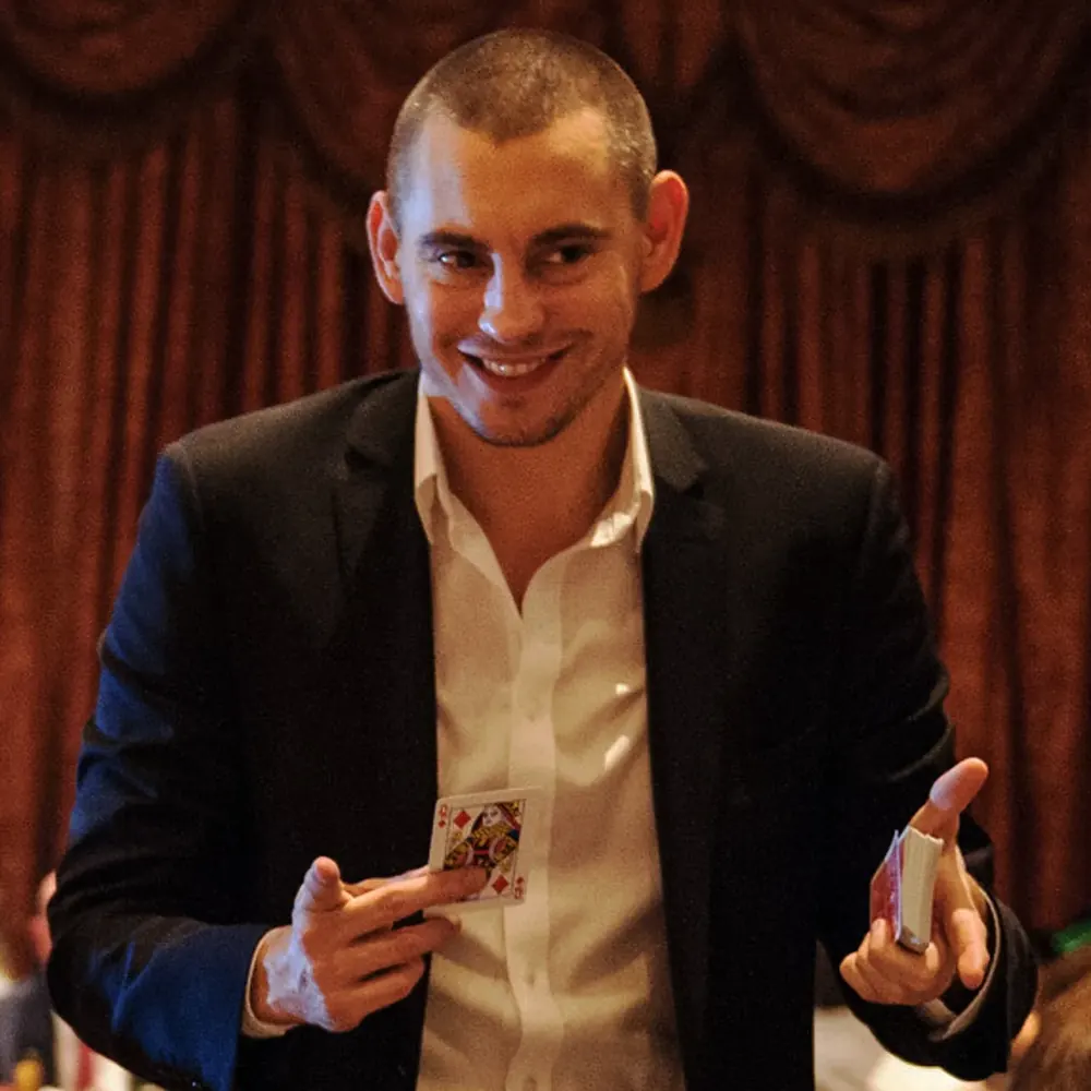 Magician Matt Parro smiling at a corporate gala dinner