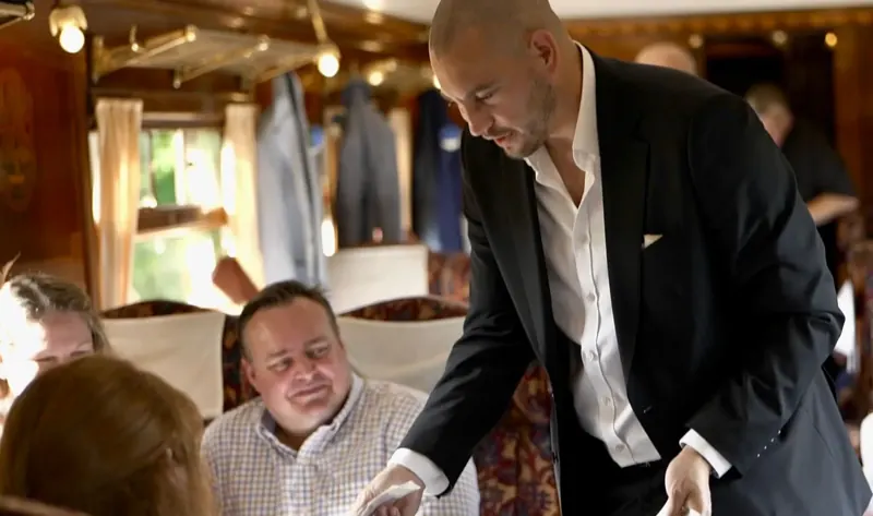 Matt Parro performing close-up magic for guests at a private dining event