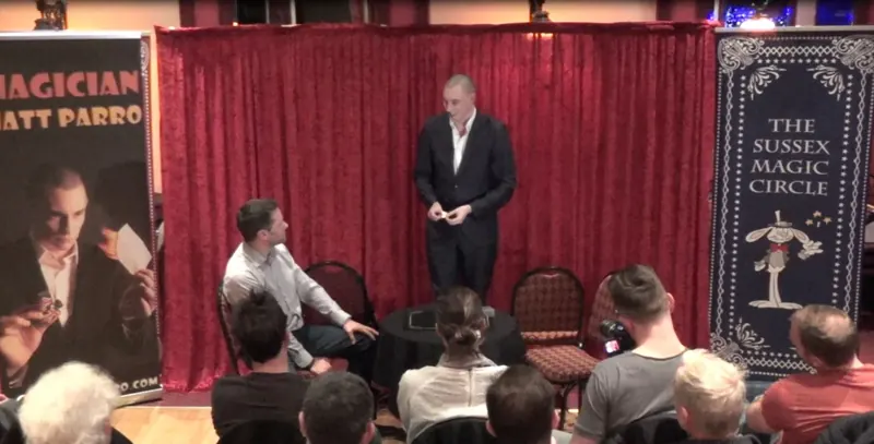 Matt Parro performing on stage at the Sussex Magic Circle