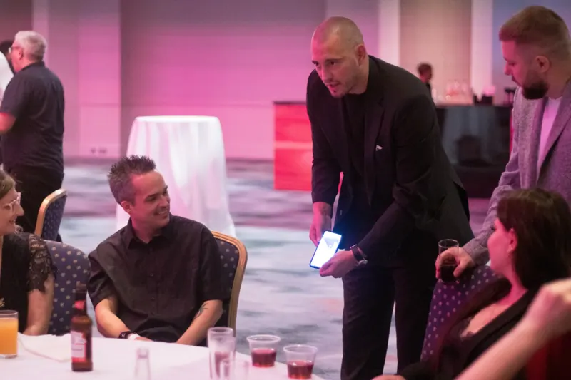 Matt Parro performing phone magic at a company party