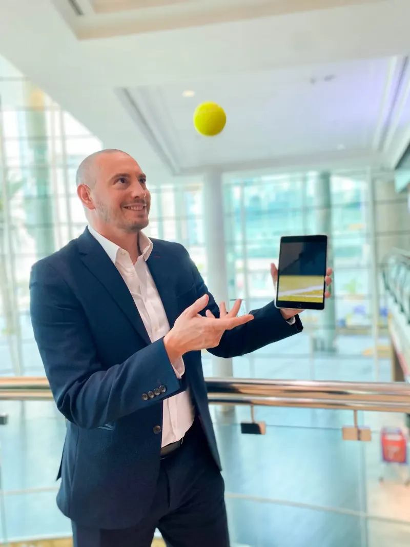 Matt Parro producing a tennis ball from an iPad