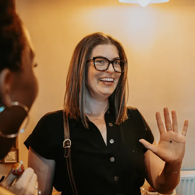 Party guest throwing her hands up in amazement