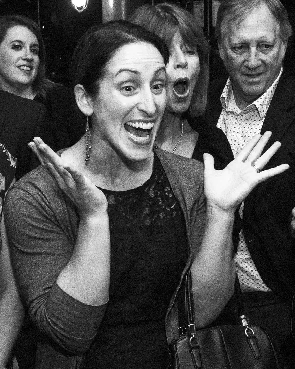 Party guests screaming at a magic trick, black and white