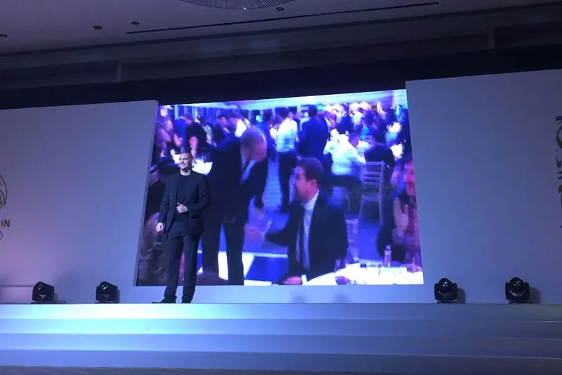 Stage magician Matt Parro on the big screen at a corporate conference