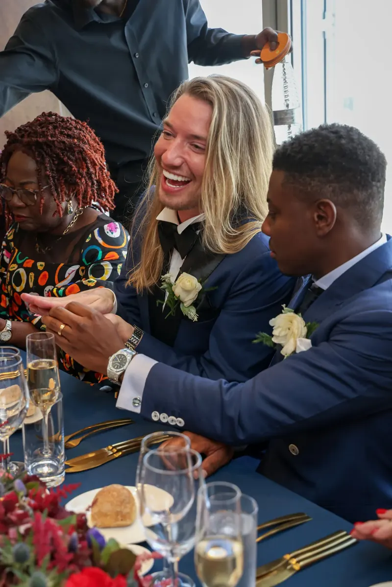 Wedding guests laughing during the wedding breakfast